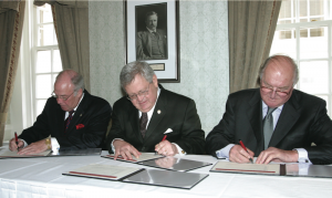 Leaders of the three founding organizations sign the charter creating IEMI on 19 May 2005.